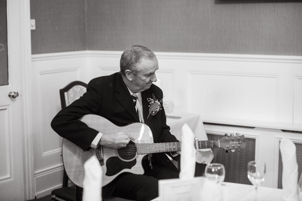 father playing guitar for wedding first dance