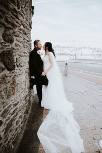 Wedding Photo of couple standing against Waterfords Viking ower