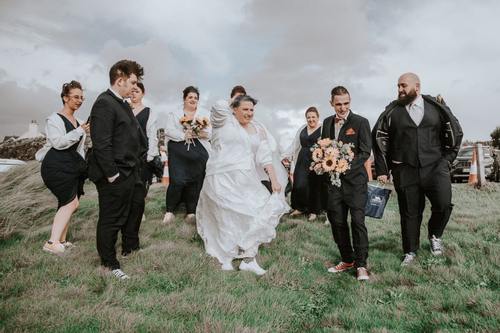 Strong wind blowing bridal parties hair and clothes around