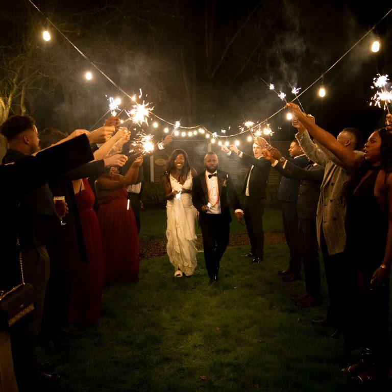 Wedding Photography of the Bride and Groom walking under sparklers held up by there guests at the Shamrock Lodge Hotel in Westmeath