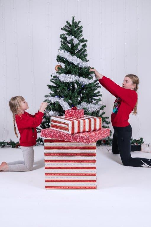girls decorating the Christmas tree during a children's Christmas mini-session in the Athlone studio