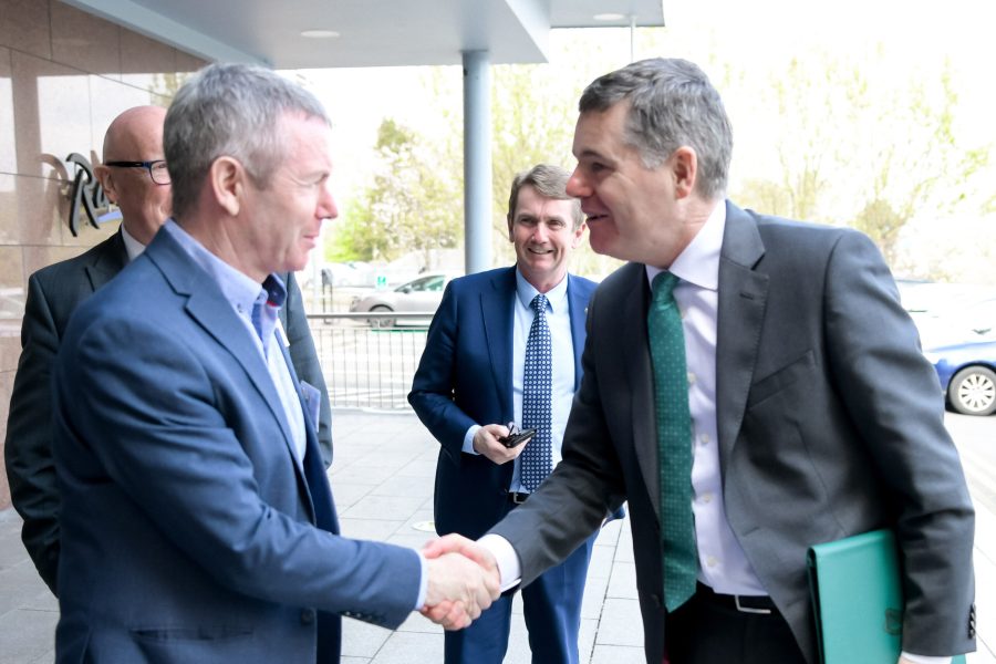 Delegates shaking hands at a conference in Athlone