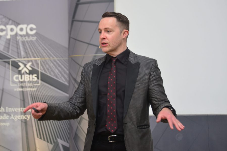 Presenter speaking on stage at a corporate event