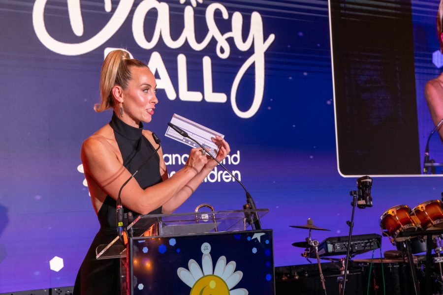 Host speaking on stage at a charity ball in Dublin