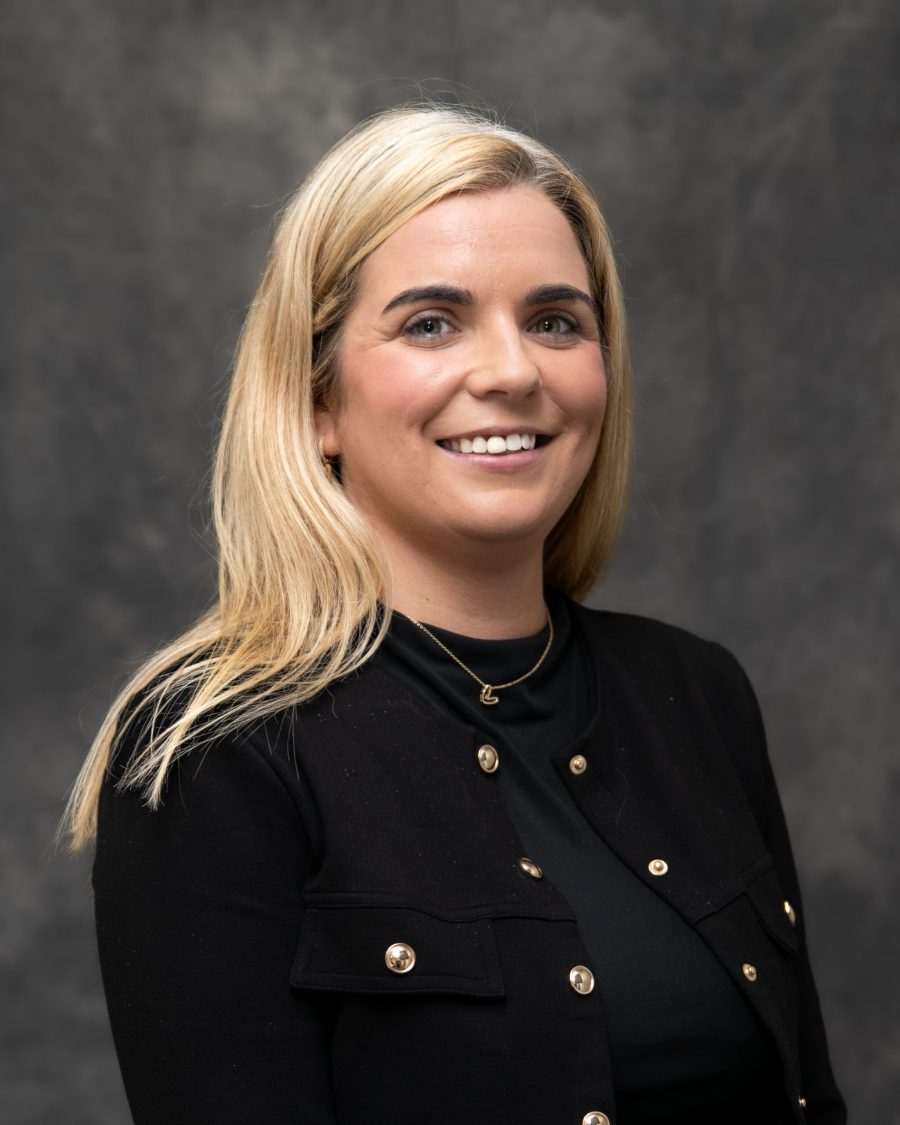 Corporate headshot on a consistent grey background