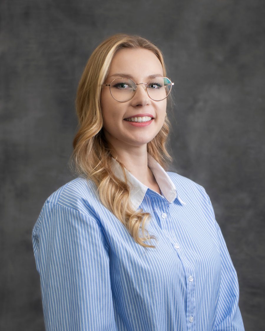 Corporate headshot of a woman in a blue shirt