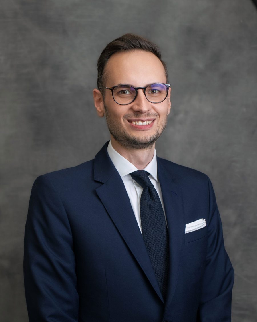 Corporate headshot of a man wearing glasses