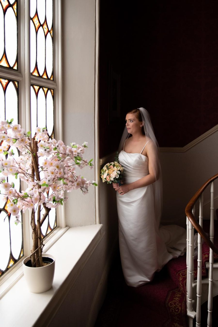 Bride in natural window light before the ceremony