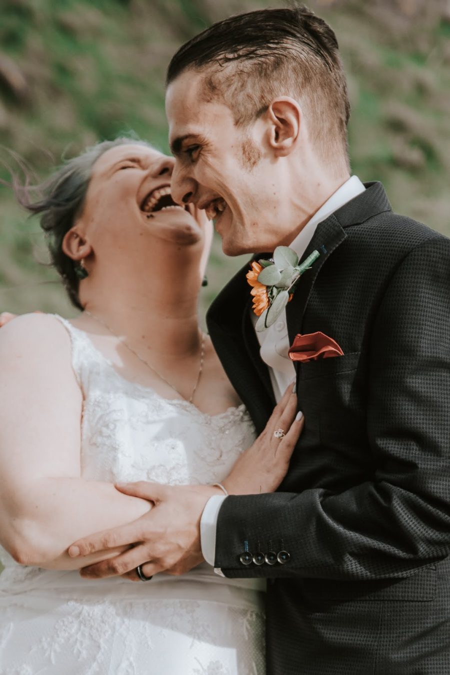 Couple laughing together on their wedding day
