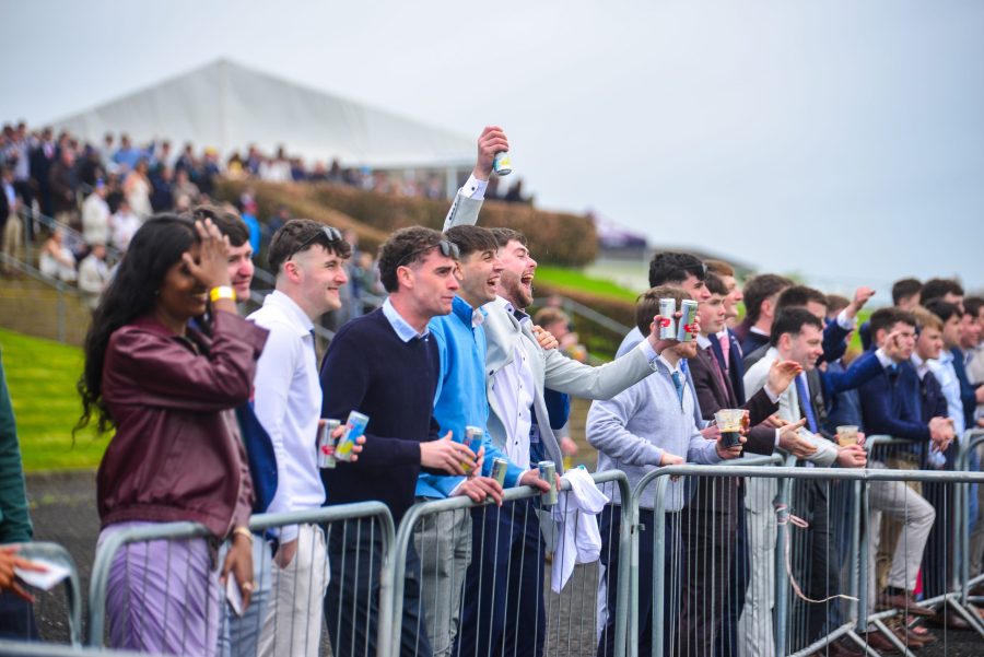Racegoers watching from the rail at a race day