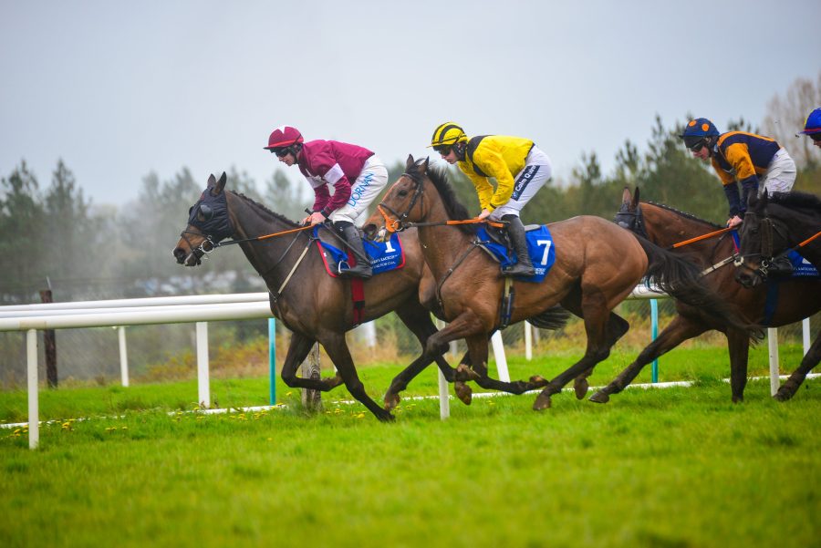Jockeys racing side by side on the turf