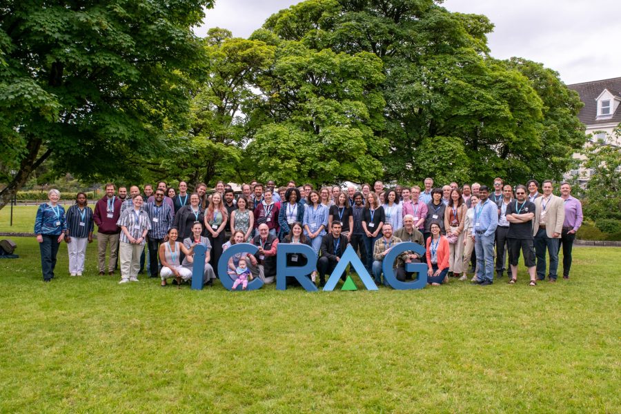 Large group photograph of delegates outside a summit venue