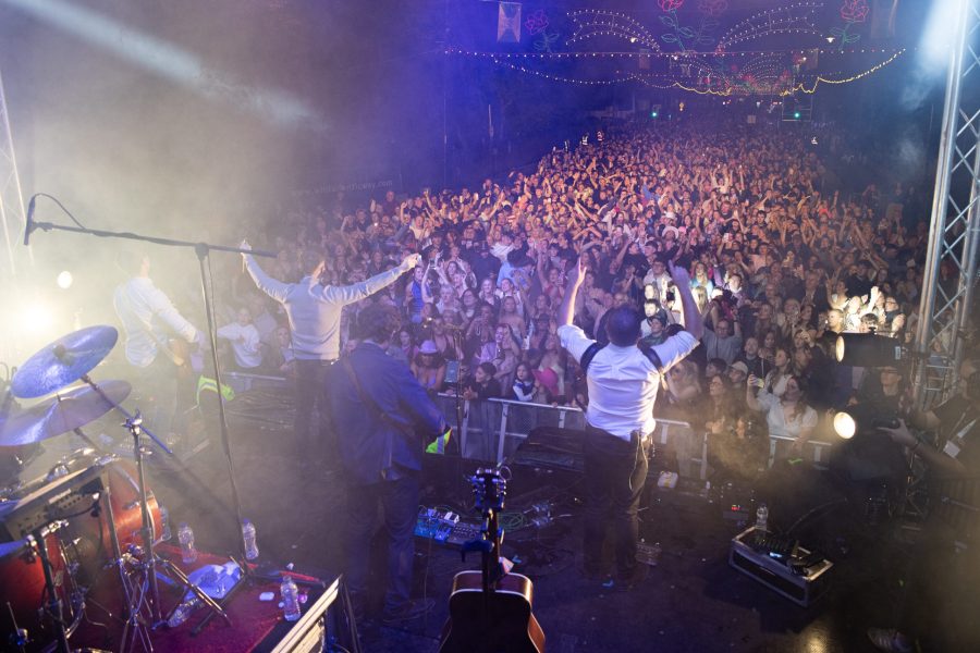 Crowd and stage lights at a large outdoor concert